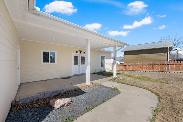 doorway to property featuring french doors, a patio area, and fence