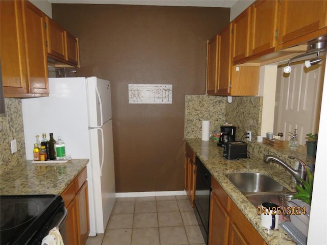 kitchen with light tile patterned floors, a sink, backsplash, black appliances, and brown cabinetry