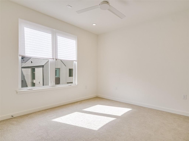 carpeted empty room featuring ceiling fan, recessed lighting, and baseboards