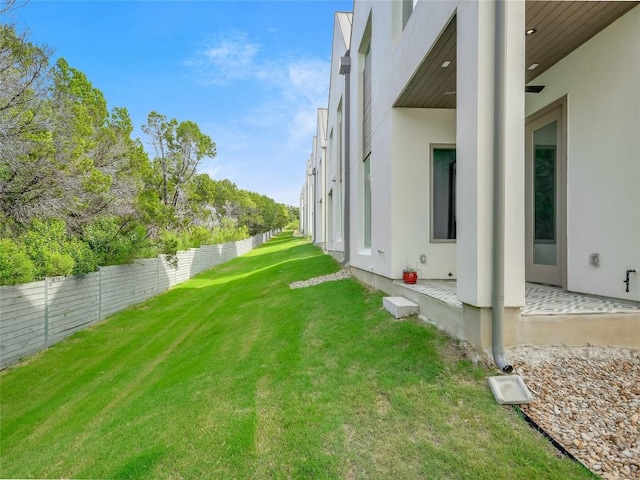 view of yard with a patio area and a fenced backyard