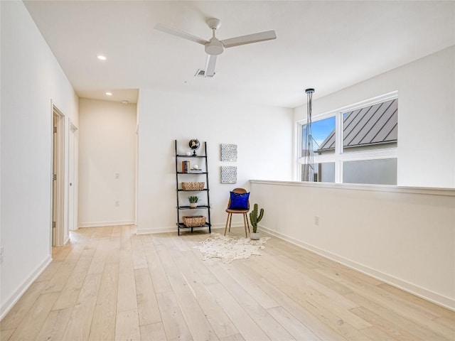 interior space with light wood finished floors, recessed lighting, visible vents, ceiling fan, and baseboards