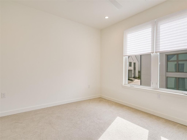 empty room with carpet, baseboards, and recessed lighting