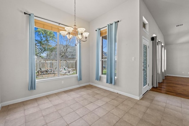 unfurnished dining area featuring a chandelier, tile patterned floors, visible vents, and baseboards