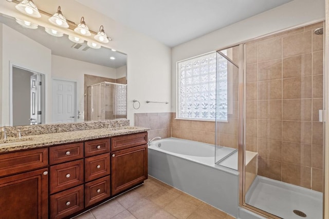 bathroom with visible vents, a bath, tile patterned floors, double vanity, and a stall shower