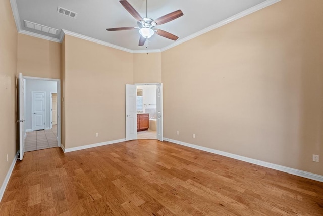 unfurnished bedroom featuring light wood finished floors, visible vents, ensuite bathroom, ornamental molding, and baseboards