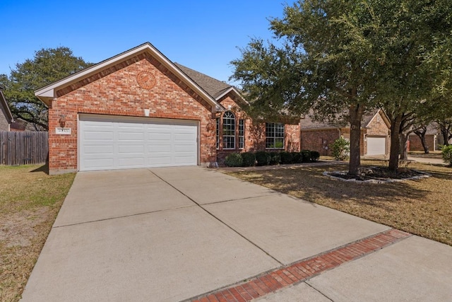 ranch-style house featuring brick siding, fence, a garage, driveway, and a front lawn