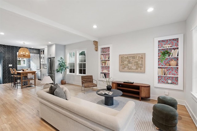 living area featuring light wood-style flooring and recessed lighting