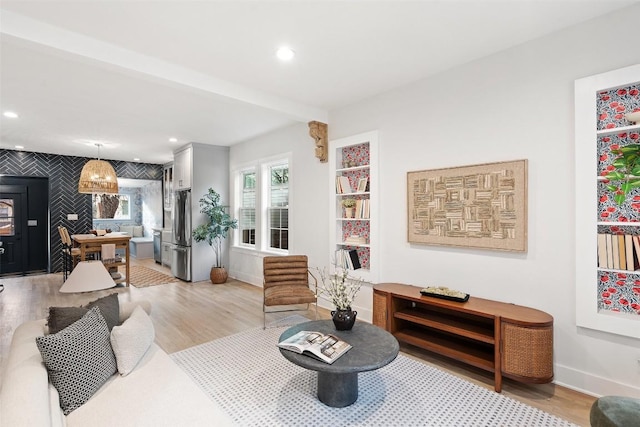 living area featuring light wood-type flooring, baseboards, and recessed lighting