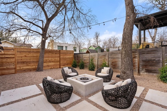 view of patio / terrace featuring an outdoor fire pit and a fenced backyard