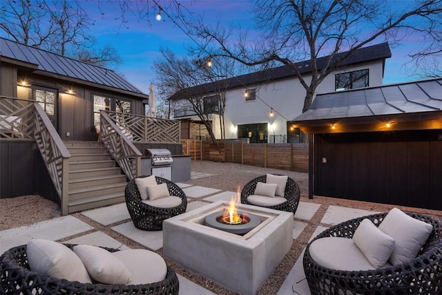 view of patio featuring an outdoor fire pit, stairs, and a fenced backyard