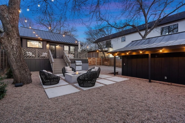 view of yard with fence, a fire pit, a deck, and a patio