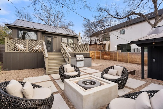 view of patio / terrace with an outdoor fire pit, stairway, a deck, and a fenced backyard