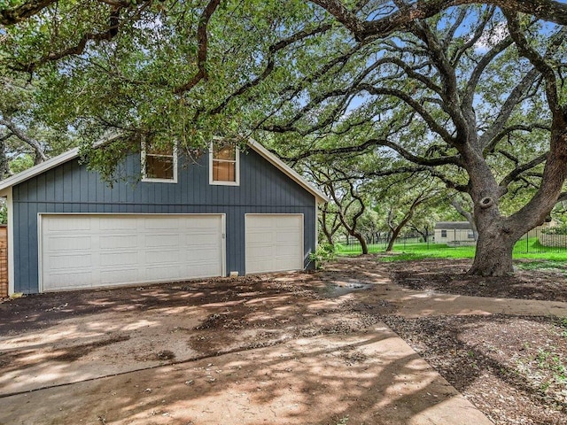 detached garage featuring fence