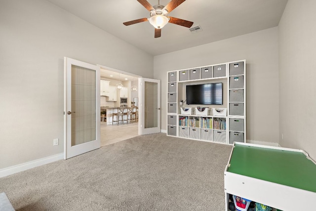 recreation room featuring ceiling fan, carpet flooring, visible vents, baseboards, and french doors