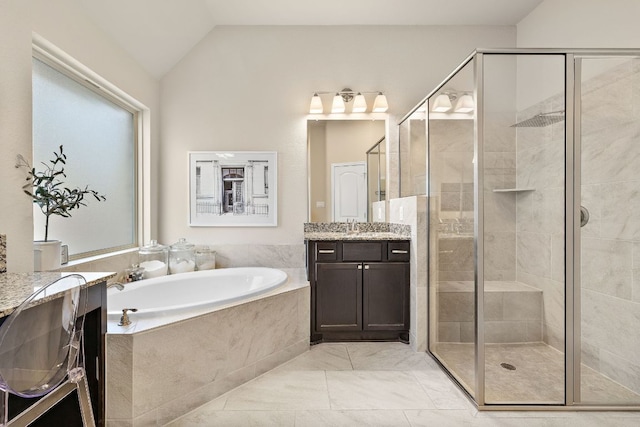 full bath featuring a stall shower, lofted ceiling, vanity, and a bath