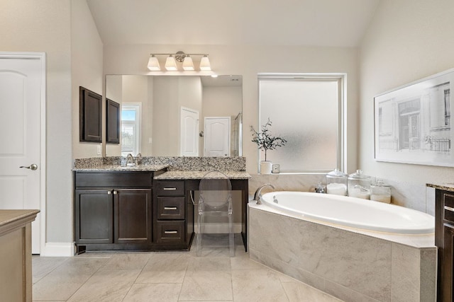 bathroom with vanity and a bath