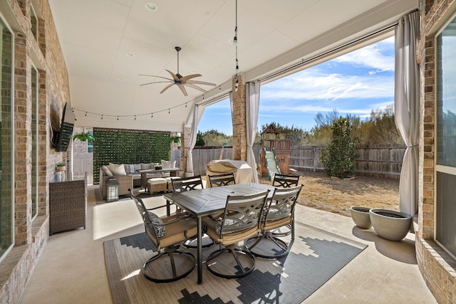 view of patio with outdoor dining space, a fenced backyard, an outdoor living space, and a ceiling fan