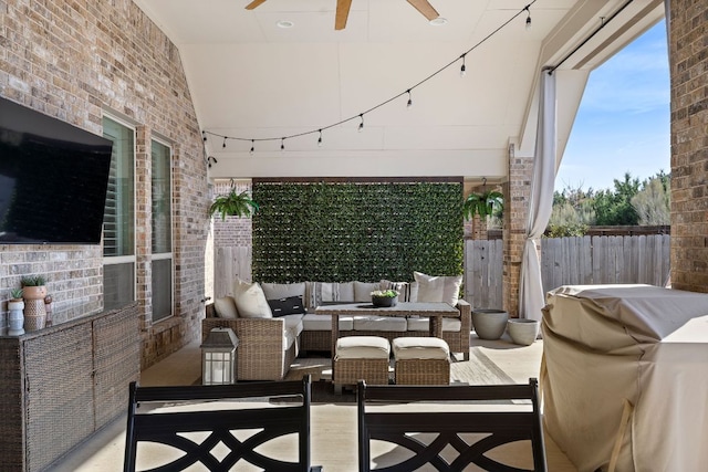 view of patio featuring grilling area, outdoor lounge area, fence, and a ceiling fan