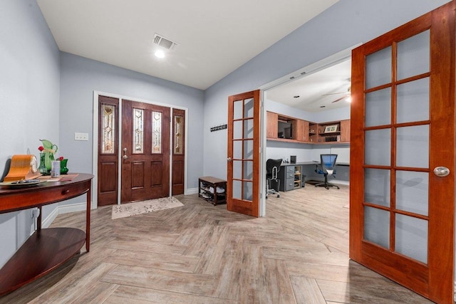 entryway featuring baseboards, visible vents, and french doors