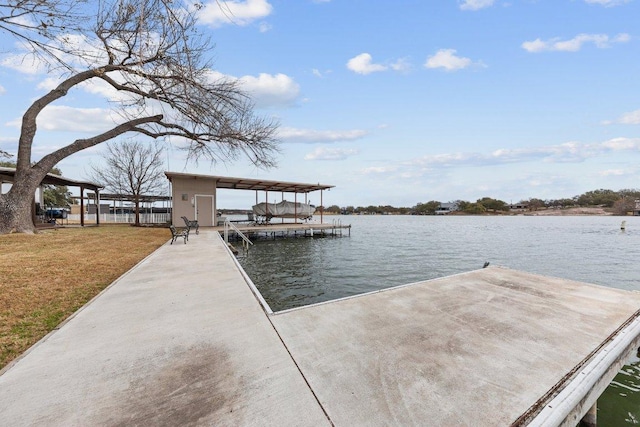 view of dock featuring a water view and a yard