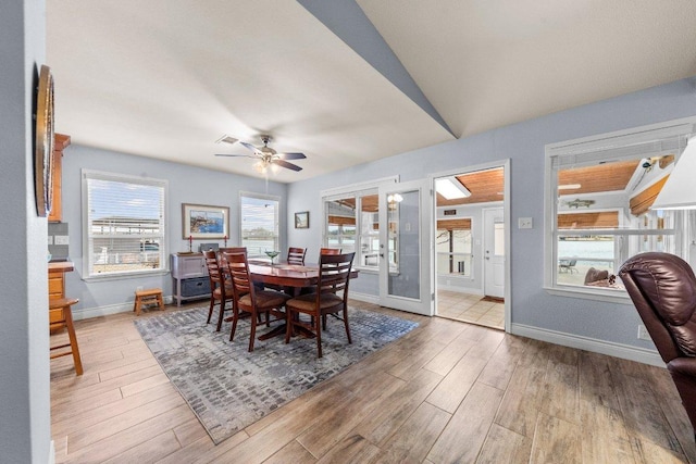 dining area with a healthy amount of sunlight, wood finished floors, and french doors