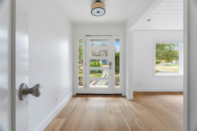 foyer featuring light wood-type flooring and baseboards