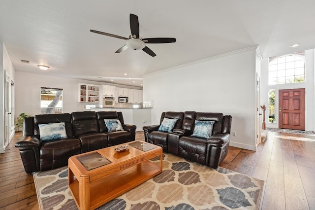 living room with ceiling fan, recessed lighting, baseboards, hardwood / wood-style floors, and crown molding