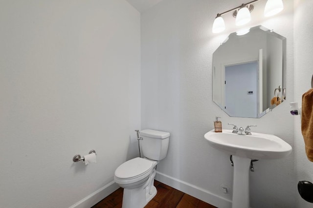 bathroom featuring wood finished floors, toilet, and baseboards