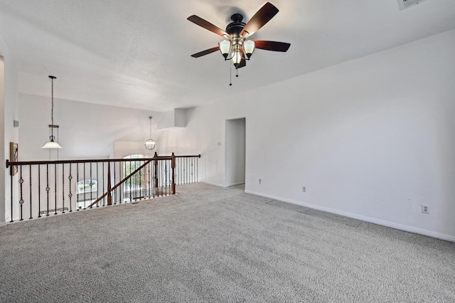 unfurnished room featuring ceiling fan, carpet flooring, and baseboards