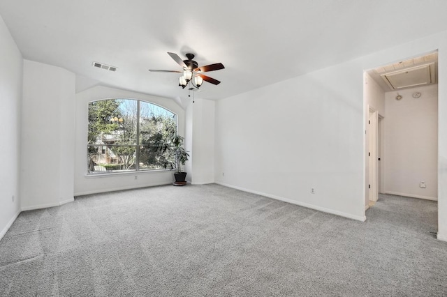 empty room featuring attic access, visible vents, baseboards, ceiling fan, and carpet floors