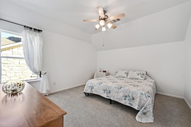 carpeted bedroom with ceiling fan, baseboards, and vaulted ceiling