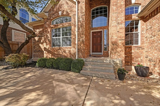 property entrance featuring brick siding