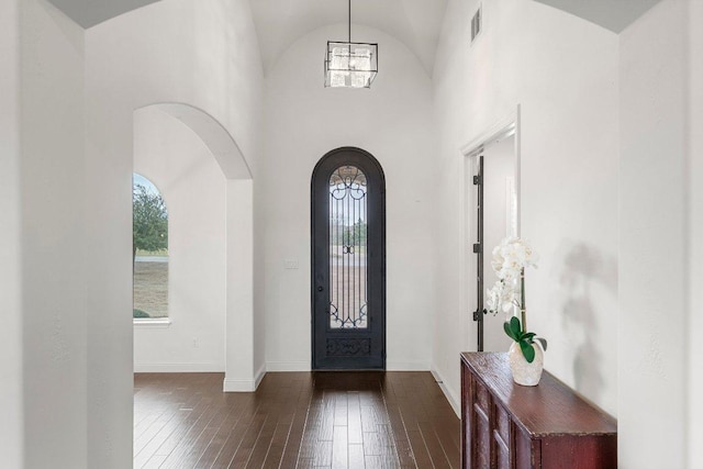 entryway featuring baseboards, visible vents, dark wood finished floors, and a wealth of natural light