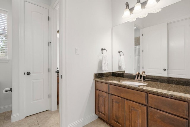 bathroom featuring baseboards, vanity, and tile patterned floors