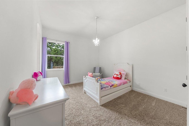 bedroom with light carpet, baseboards, and a notable chandelier