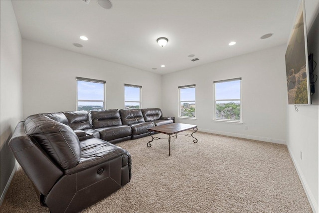 carpeted living area with recessed lighting, visible vents, and baseboards