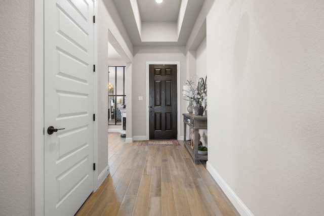 entryway featuring light wood-style flooring and baseboards