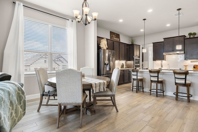 dining area with recessed lighting, visible vents, an inviting chandelier, light wood-style floors, and baseboards