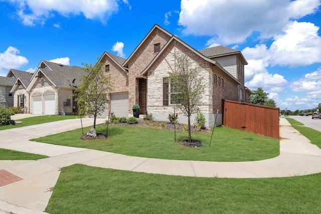 french country inspired facade featuring driveway, brick siding, a front lawn, and an attached garage