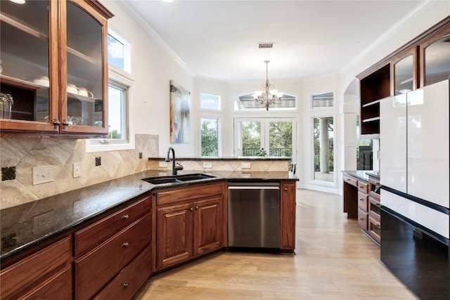 kitchen with visible vents, dishwasher, a peninsula, crown molding, and a sink