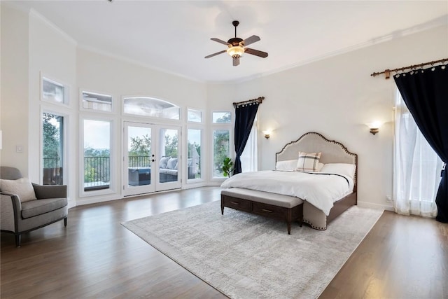 bedroom with access to outside, multiple windows, ornamental molding, and wood finished floors