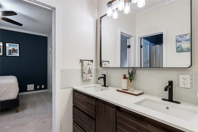 full bath featuring ornamental molding, a sink, ceiling fan, and double vanity