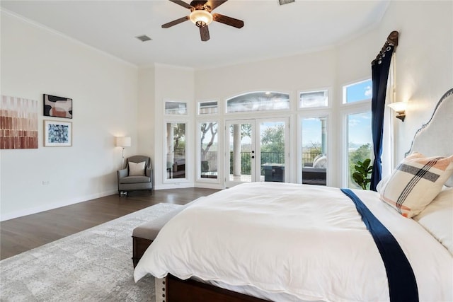 bedroom featuring wood finished floors, visible vents, baseboards, access to outside, and crown molding