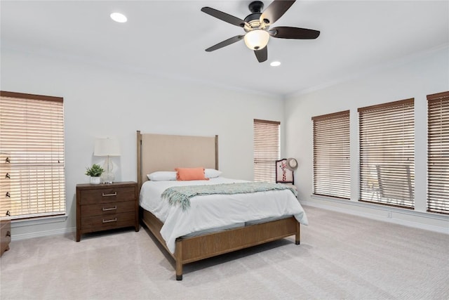 bedroom with baseboards, crown molding, recessed lighting, and light colored carpet