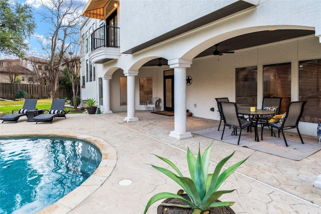 view of pool with a patio area, fence, and a ceiling fan