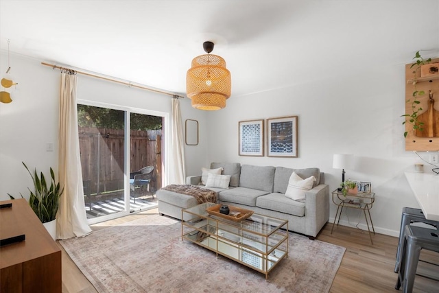 living area featuring baseboards and wood finished floors