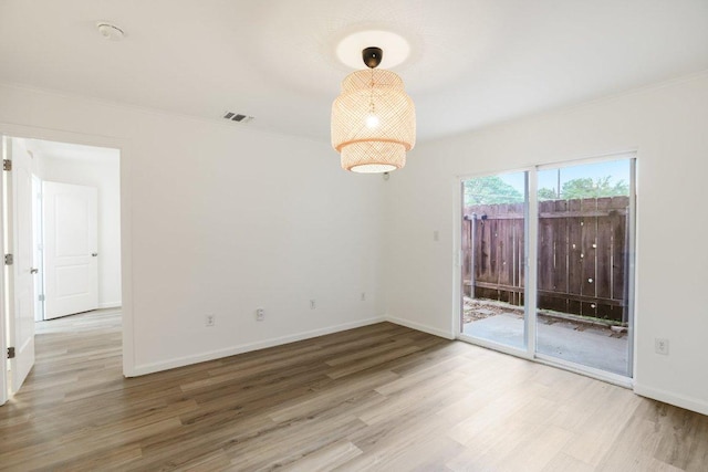 1422 Collier St Unit 102, Austin, TX 78704 - empty room with wood finished floors, baseboards, and crown molding
