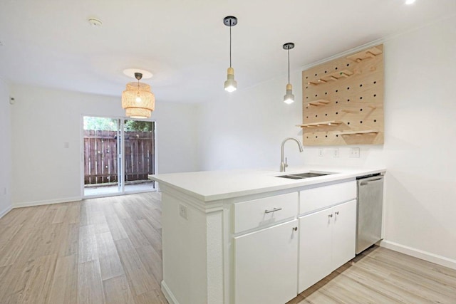 1422 Collier St Unit 102, Austin, TX 78704 - kitchen featuring dishwasher, a sink, light wood finished floors, a peninsula, and hanging light fixtures