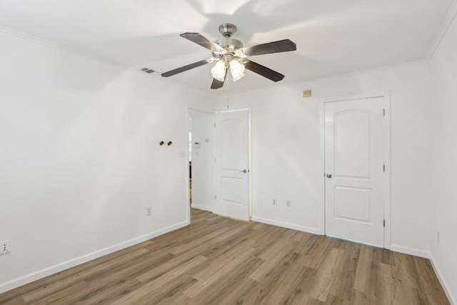 1422 Collier St Unit 102, Austin, TX 78704 - unfurnished bedroom featuring wood finished floors, crown molding, baseboards, and ceiling fan
