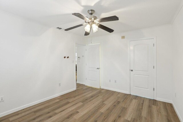 1422 Collier St Unit 102, Austin, TX 78704 - unfurnished bedroom featuring wood finished floors, ornamental molding, and ceiling fan